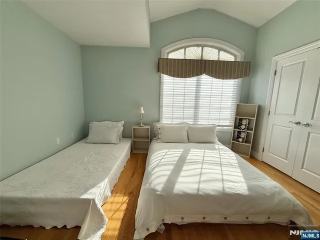 a bedroom with a bed and a large window