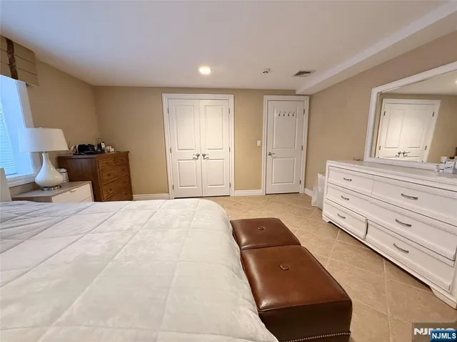 a bedroom with a bed and a mirror