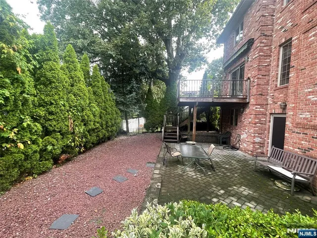 a view of a patio with table and chairs and potted plants