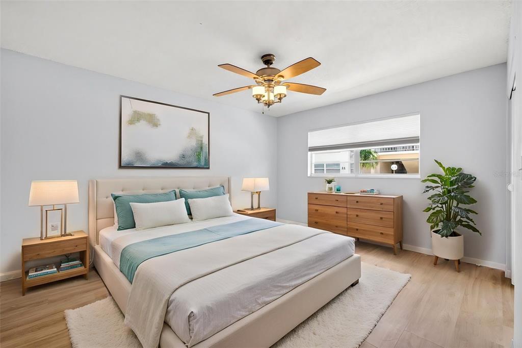 5197 Silent Loop, Unit 124 New Port Richey, FL 34652 - Photo 30 of 55 a bedroom with a bed and a chandelier