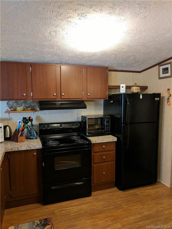 2158 Coopers Gap Road Rutherfordton, NC 28139 - Photo 11 of 27 a kitchen with a refrigerator and a stove