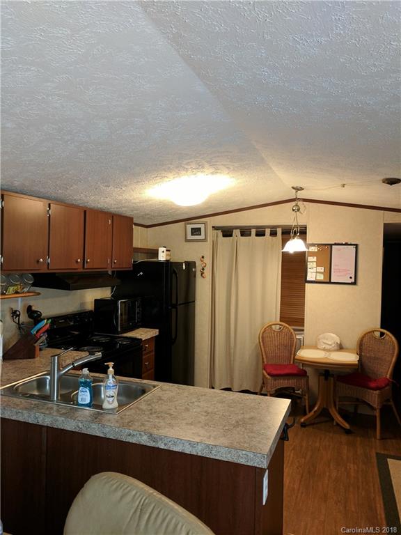 2158 Coopers Gap Road Rutherfordton, NC 28139 - Photo 12 of 27 a kitchen with a refrigerator and a stove top oven