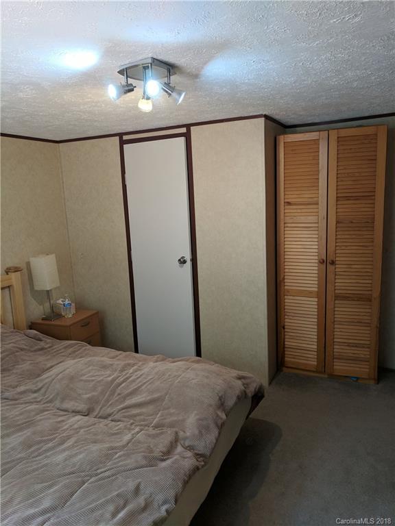 2158 Coopers Gap Road Rutherfordton, NC 28139 - Photo 17 of 27 a bedroom with a bed and a walk in closet