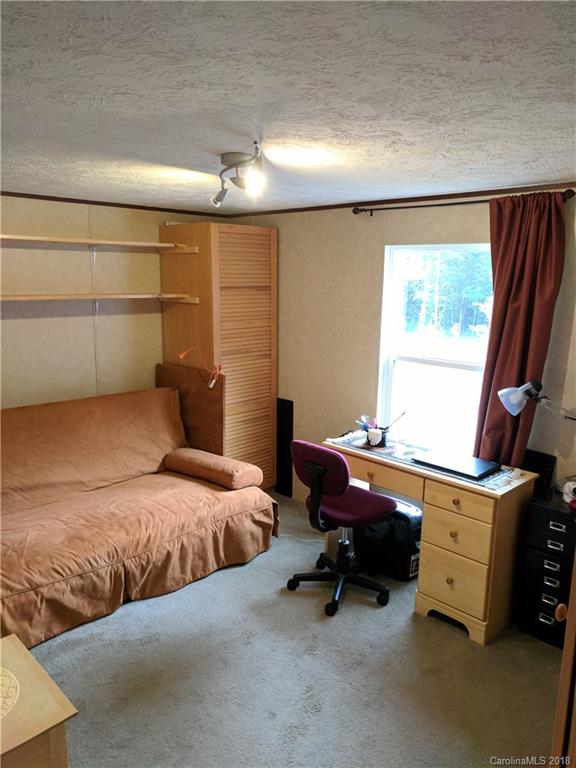 2158 Coopers Gap Road Rutherfordton, NC 28139 - Photo 19 of 27 a bedroom with a bed and a desk