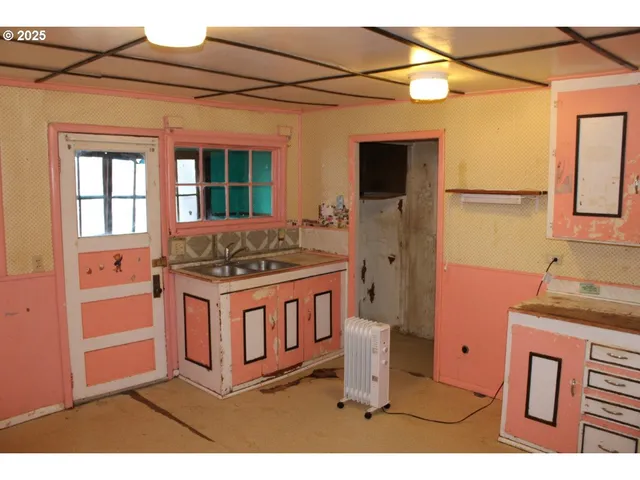 a kitchen with a stove a sink and a refrigerator