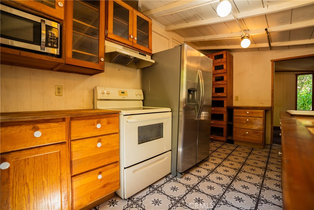 0 Hot Springs Canyon Road, Unit 26 Trabuco Canyon, CA 92679 - Photo 44 of 59 a kitchen with a refrigerator and a stove