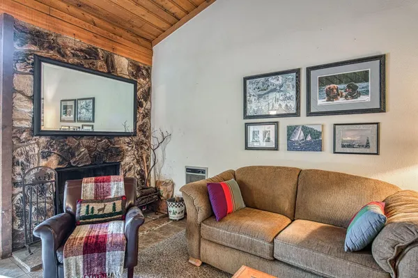 a view of a dining room with furniture and a chandelier