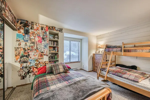 a bedroom with a bed couch and a window