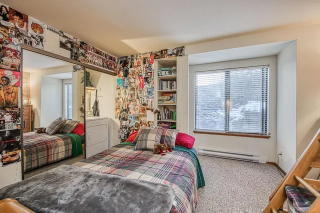 a bedroom with a bed couch and a window