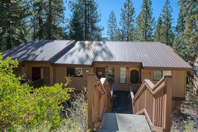 a view of a dining room with furniture and a chandelier