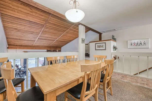 a kitchen with stainless steel appliances granite countertop a sink and a stove next to a window