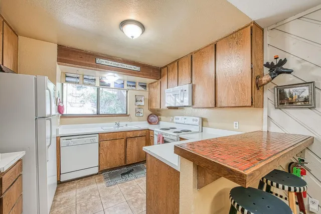 a kitchen with a stove a sink and a microwave