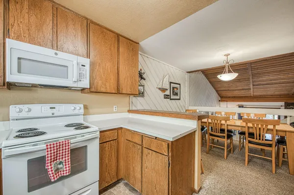 a view of a patio with table and chairs