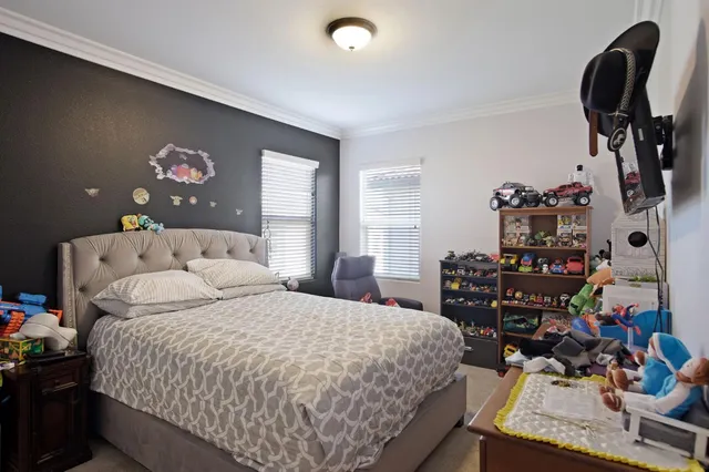 a bedroom with bed and dresser