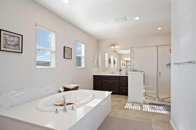 a bathroom with a tub sink and mirror