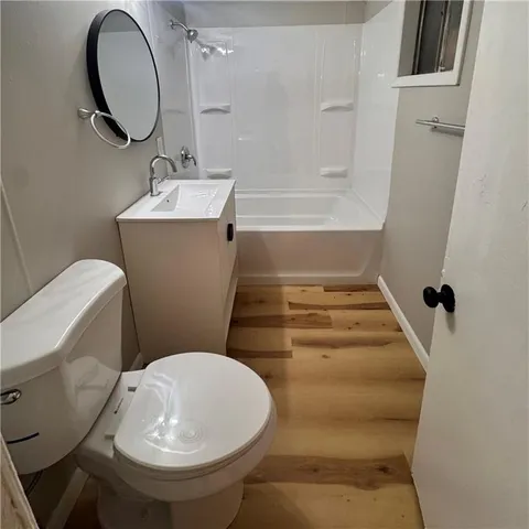 a bathroom with a sink toilet and a mirror