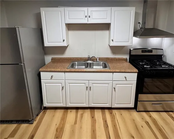 a kitchen with white cabinets and white appliances
