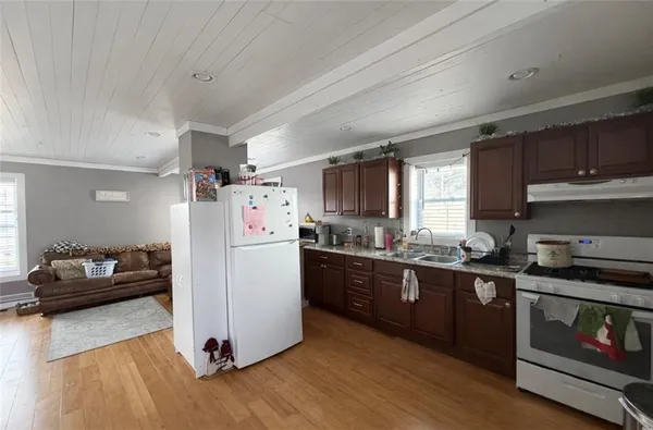 a kitchen with sink cabinets and wooden floor