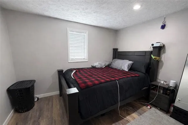 a bedroom with a bed and a chair