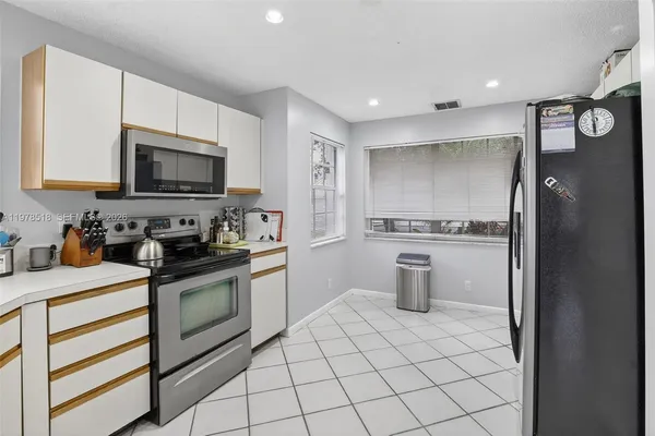 a kitchen with a stove a sink and a refrigerator