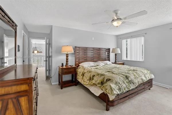 a bed sitting in a spacious bedroom next to a window