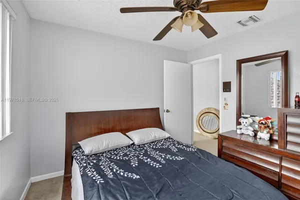 a bedroom with furniture and wooden floor