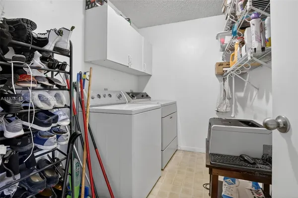 a utility room with dryer washer and other items