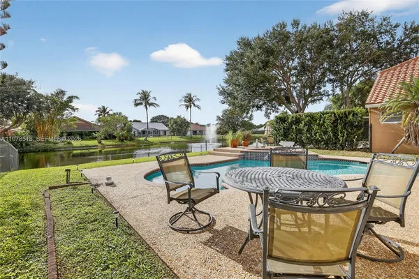 a view of a swimming pool with lounge chairs