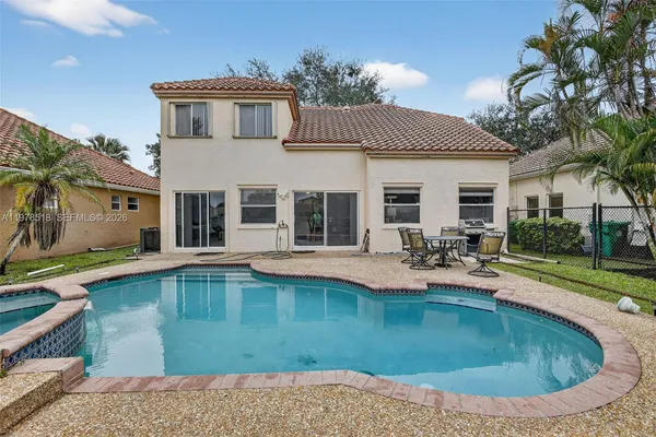 a view of a house with pool porch and chairs