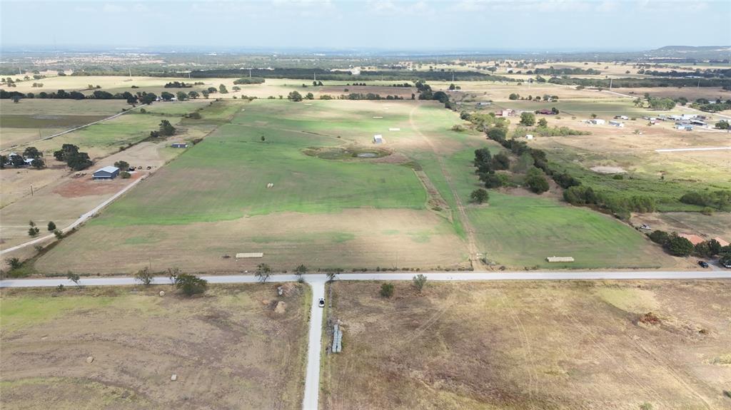 2101 Billings Road Tolar, TX 76476 - Photo 12 of 23 Expansive rural landscape featuring a mix of open fields and scattered trees