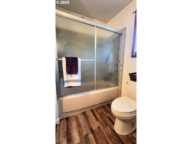 a bathroom with a toilet and a shower