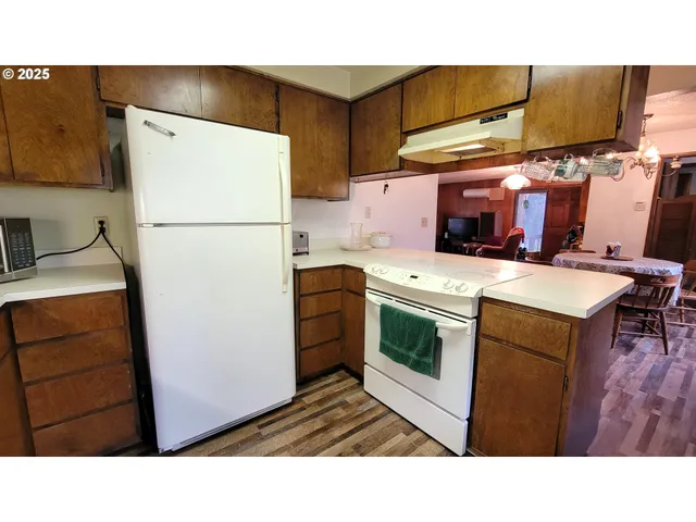 a kitchen with a refrigerator and a stove