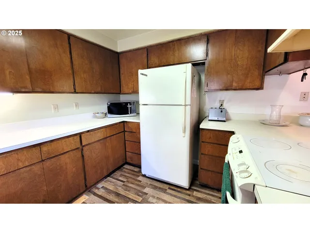 a kitchen with a refrigerator and a sink