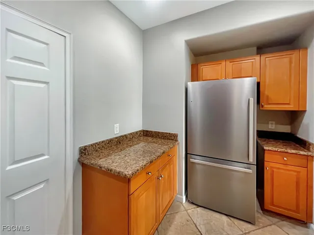 a kitchen with stainless steel appliances granite countertop a refrigerator and a sink