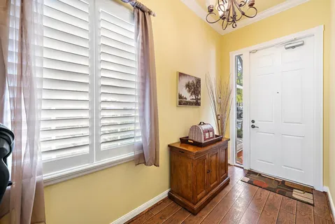 a bathroom with a window a sink and a mirror