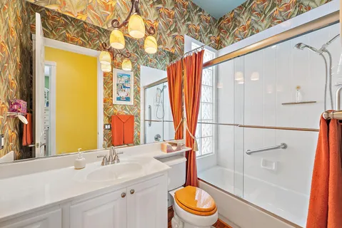 a bathroom with a sink a toilet and shower