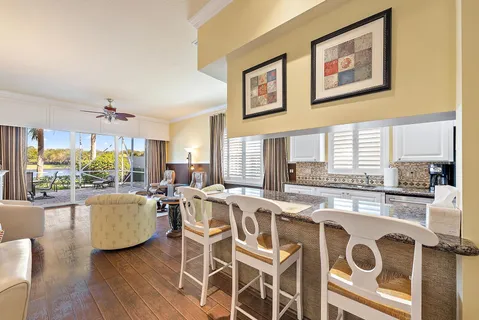 a living room with furniture dining table and wooden floor