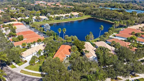 an aerial view of a house with a yard and lake view