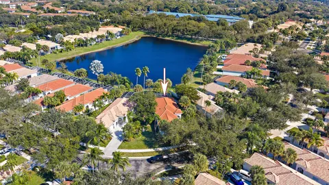 an aerial view of a house with a yard and lake view