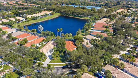 an aerial view of a house with a yard and lake view