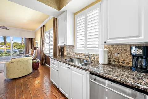 a kitchen with sink refrigerator and window