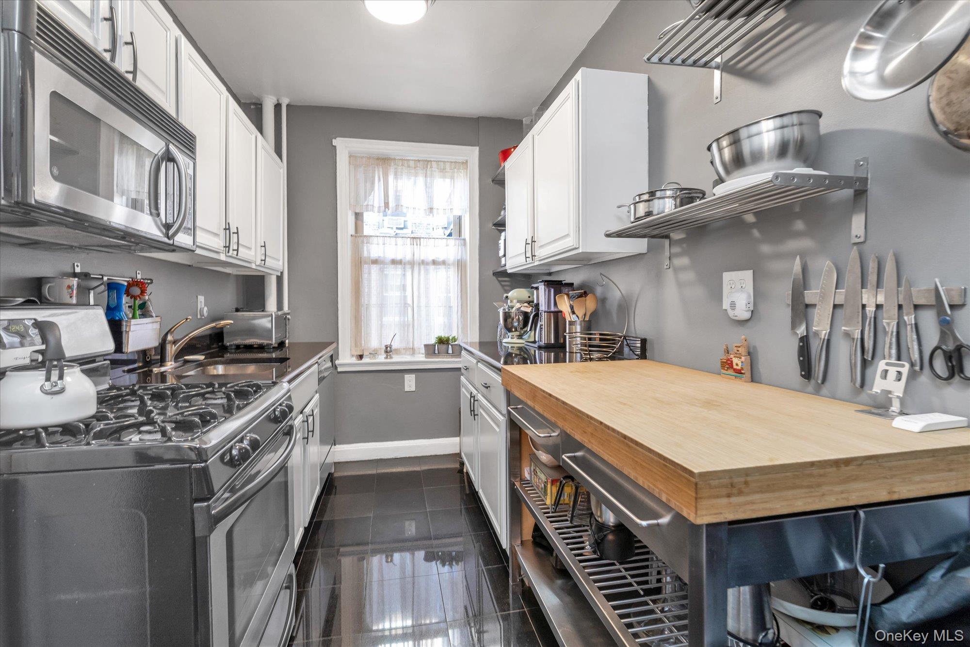 48-55 43rd Street, Unit 3F Queens, NY 11377 - Photo 6 of 12 a kitchen with stainless steel appliances granite countertop a stove and a sink