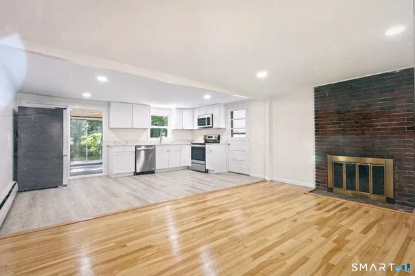 a view of a kitchen with a sink cabinets and a fireplace