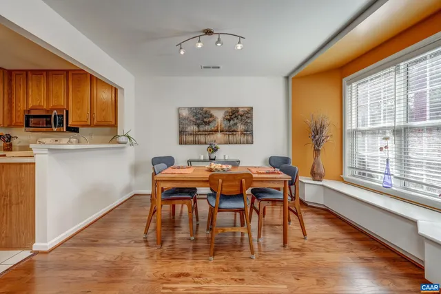 a view of a dining room with furniture window and wooden floor
