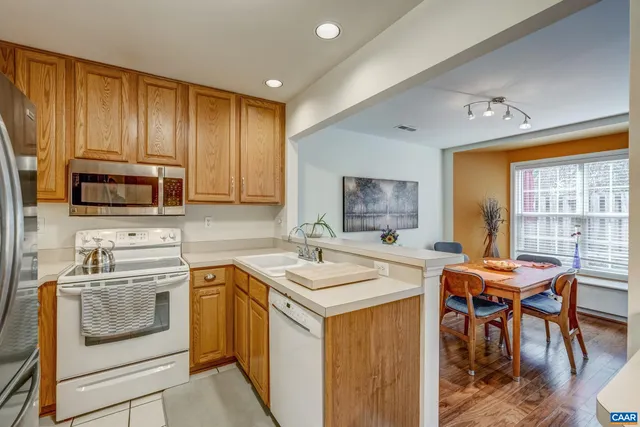 a kitchen with a stove a sink and a microwave
