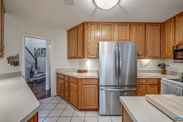 a kitchen with a refrigerator a stove a sink dishwasher and cabinets with wooden floor