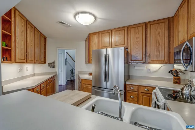 a kitchen with refrigerator and cabinets
