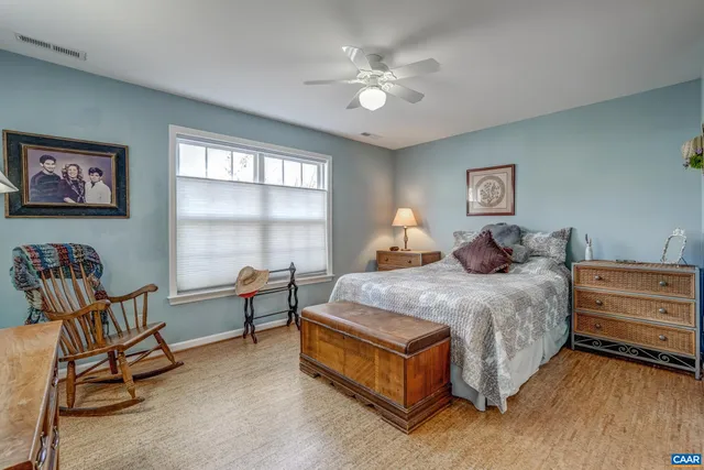 a spacious bedroom with a bed and a chandelier