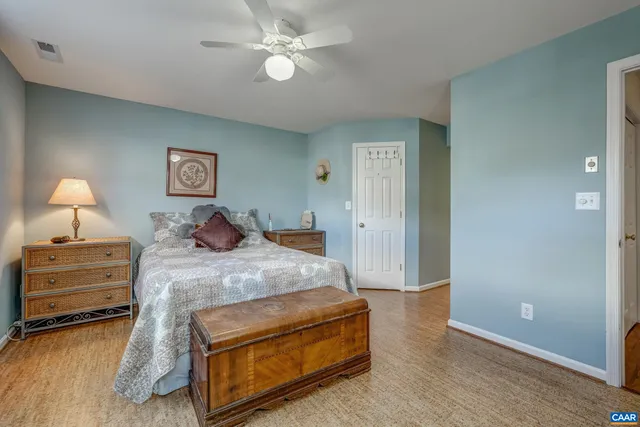 a bed room with a bed and a ceiling fan