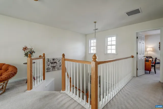a view of a livingroom with a window and stairs